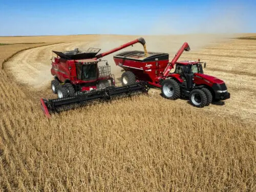 In this image taken with a drone, Jason Kwapi, left, operates a combine during soybean harvesting on the Voss farm near Palo, Iowa, Wednesday, Oct. 2, 2024.