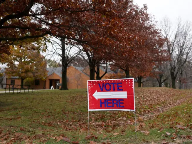 A "Vote Here" sign is seen on Election Day on Nov. 5, 2024, at Perfect Games in Ames, Iowa.