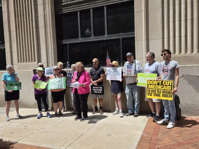 Dr. Tammy Wells speaks during a June 22 rally in front of Rep. Mariannette Miller-Meeks's Davenport office about what Wells describes as a worsening healthcare system in Iowa.