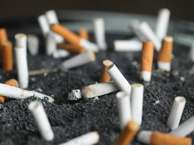 This March 28, 2019 photo shows cigarette butts in an ashtray in New York. On Tuesday, March 9, 2021.